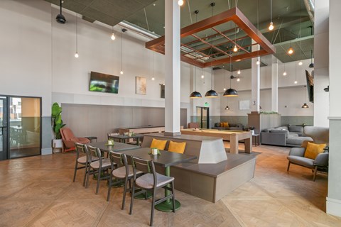 A modern dining area with a long table and chairs.
