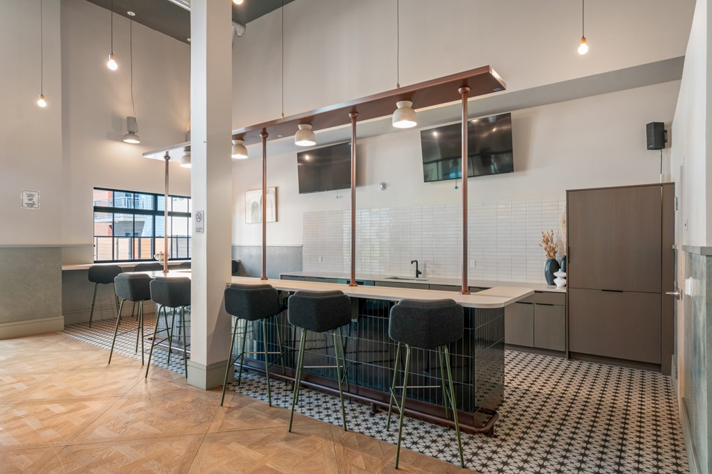 A kitchen with a bar area and a sink.