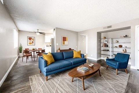 A living room with a blue couch and a coffee table.
