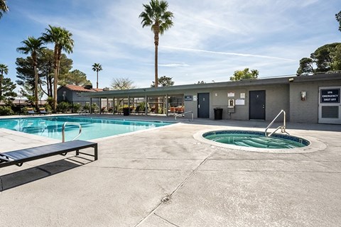 A pool area with a small pool and a hot tub.