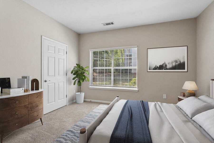 Bedroom with a large bed and a window