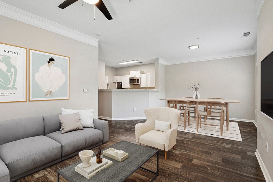 a living room and kitchen with a couch and a table