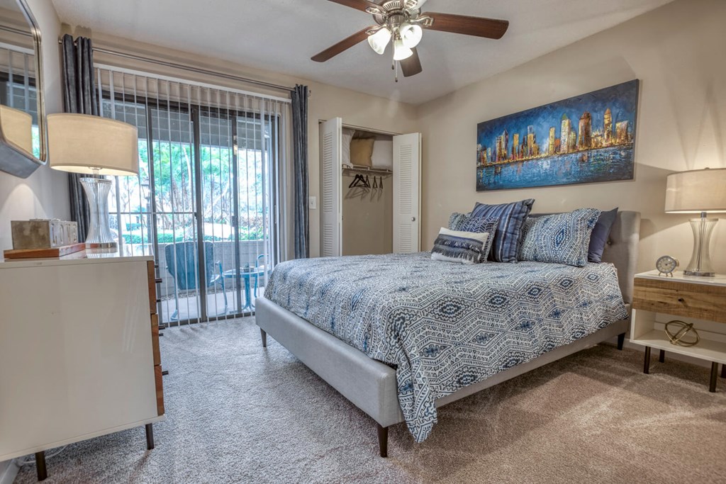 Bedroom with a bed and a ceiling fan at Huntington Place Apartments in Sarasota, Florida