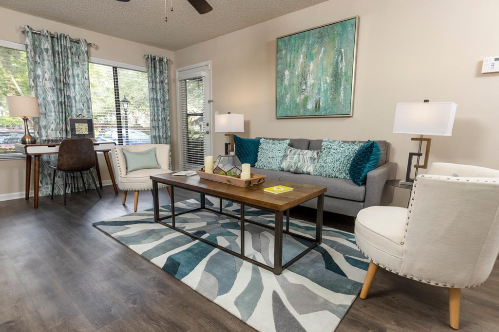 Living room with a couch and a table at Huntington Place Apartments in Sarasota, Florida
