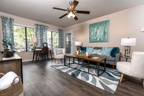 a living room with a ceiling fan and a couch