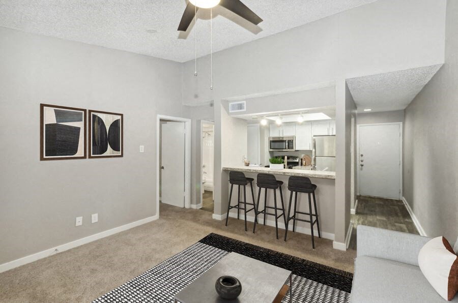a view of a dining room with a table and chairs