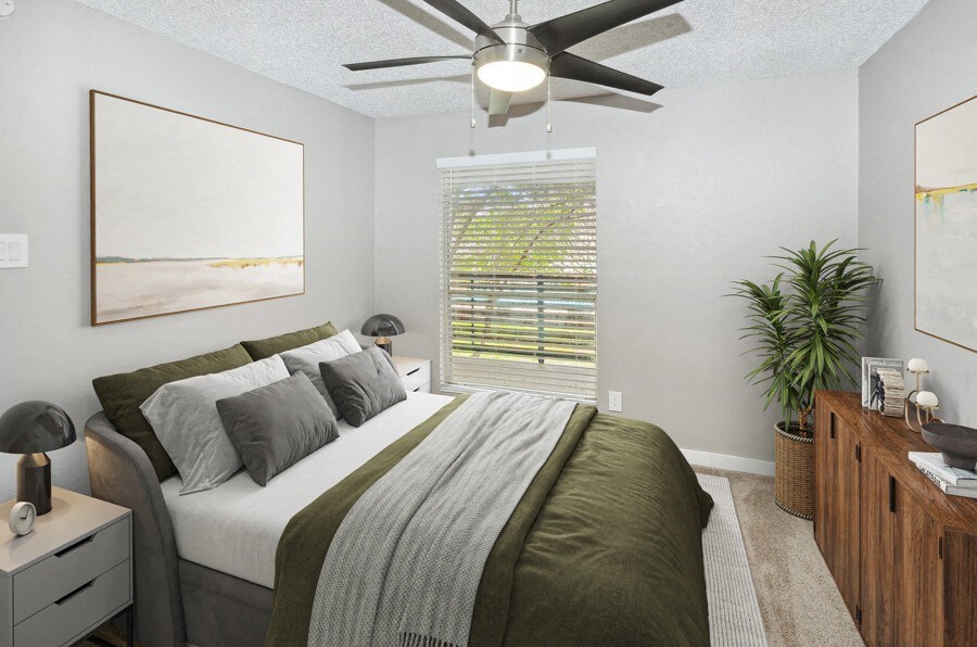 a bedroom with a large bed and a ceiling fan