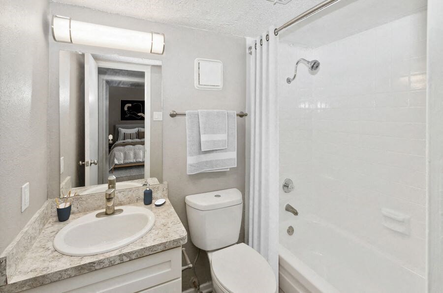 a bathroom with a sink toilet and a shower