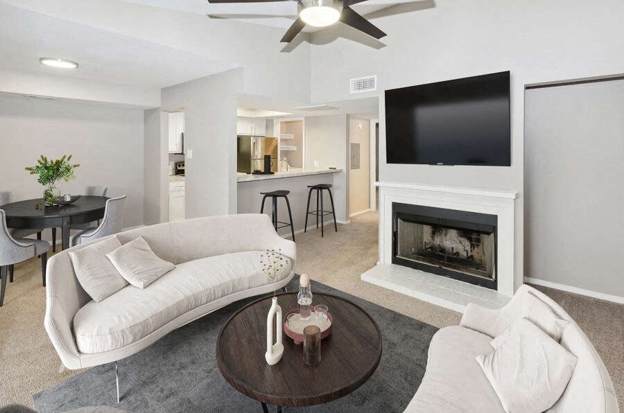a living room with a white couch and a fireplace