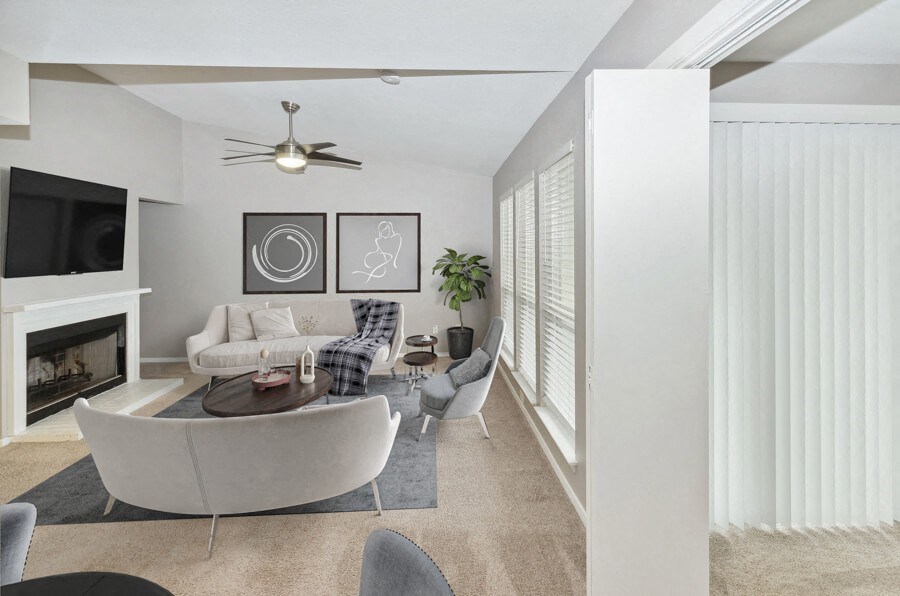 a living room with white furniture and a fireplace