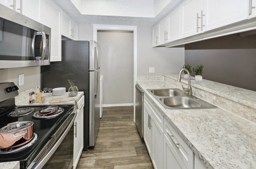 a kitchen with granite counter tops and stainless steel appliances