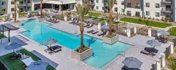Community Swimming Pool with Pool Furniture at Glen 91 Apartments located in Glendale, AZ.
