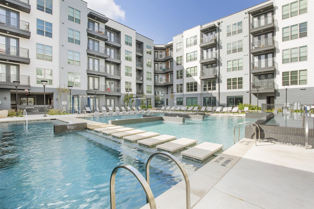 a swimming pool in front of an apartment building