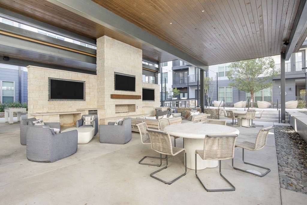 the lobby of a building with tables and chairs