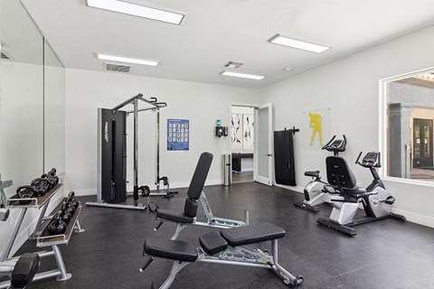 Apartments Near Nellis Air Force Base - Monterra - On Site Fitness Center With Weight Machines, Free Weights, Recumbent Bikes, And Bright Overhead Lighting