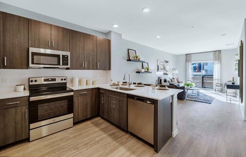 a kitchen with a sink and a stove and a microwave