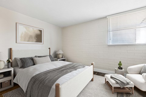 One-Bedroom Apartments in Camelback East Village, AZ - Arcadia on 49th - A Bright Bedroom With A White Upholstered Bed, Neutral Bedding, Side Tables With Lamps, And A Large Window.