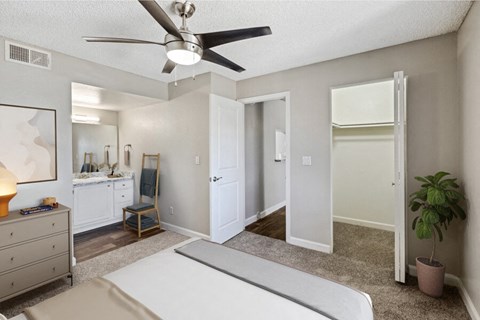 a bedroom with a bed and a ceiling fan