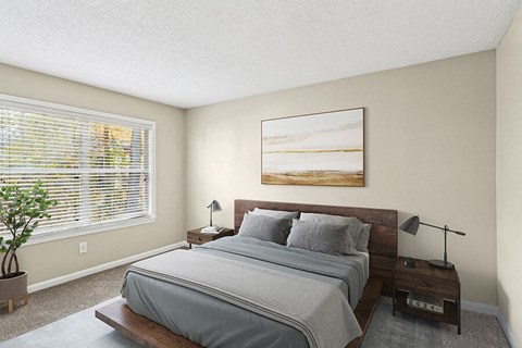 A bedroom with a large bed and a painting on the wall.