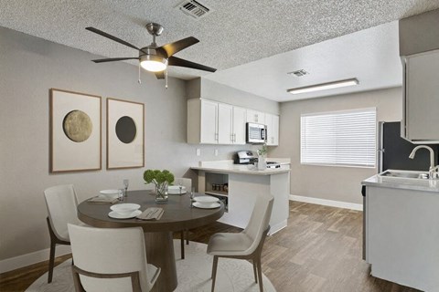 a kitchen and dining room with a table and chairs