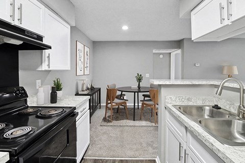 an open kitchen and dining room with a table and chairs