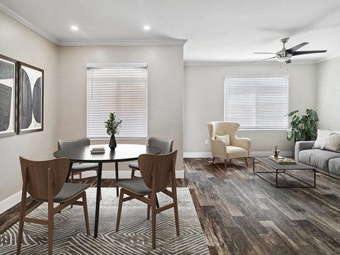 A dining room with a round table and chairs.