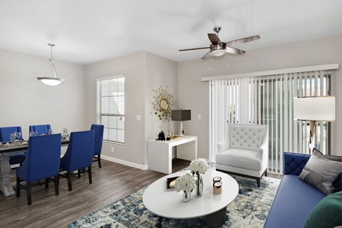 A living room with a dining table and chairs.
