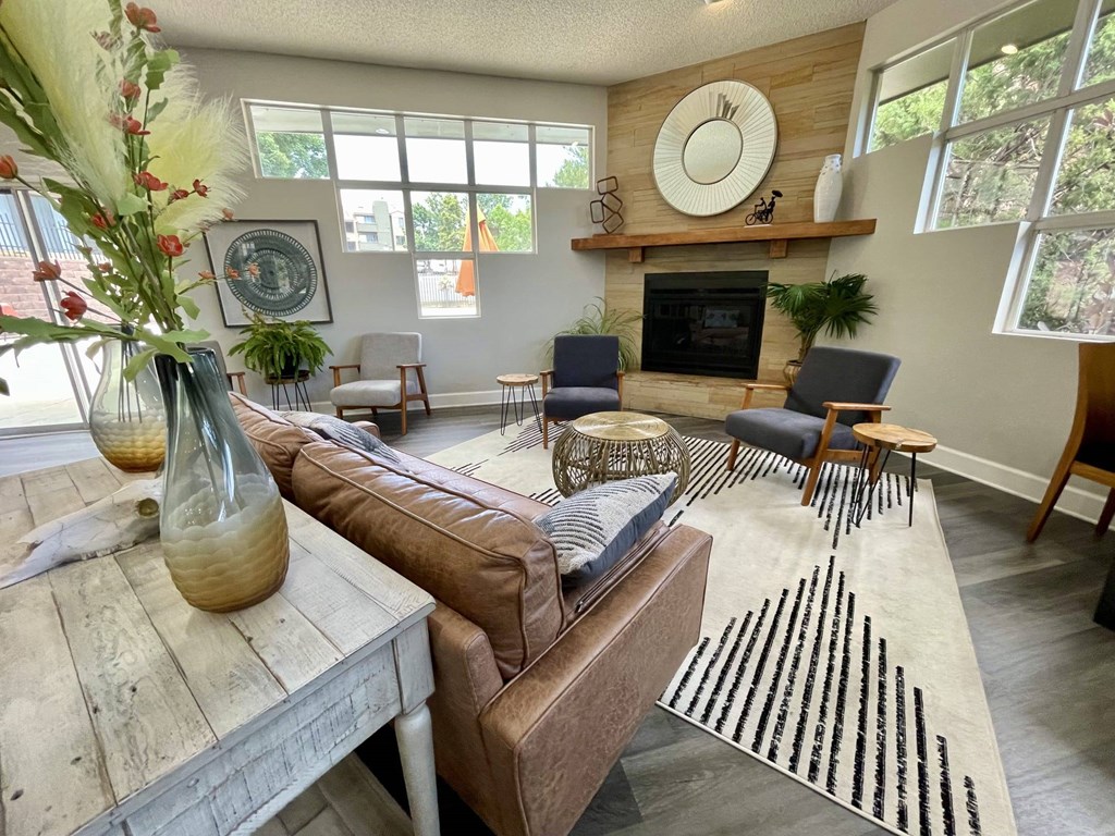 A living room with a brown couch and a fireplace.