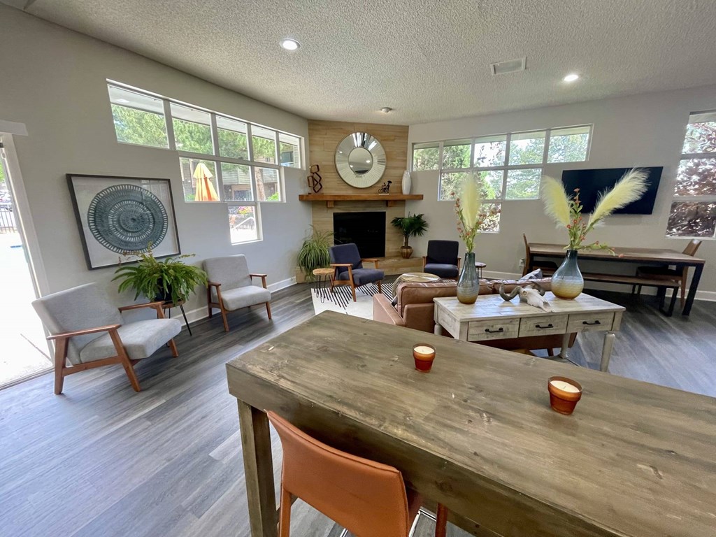 A dining room with a wooden table and chairs.