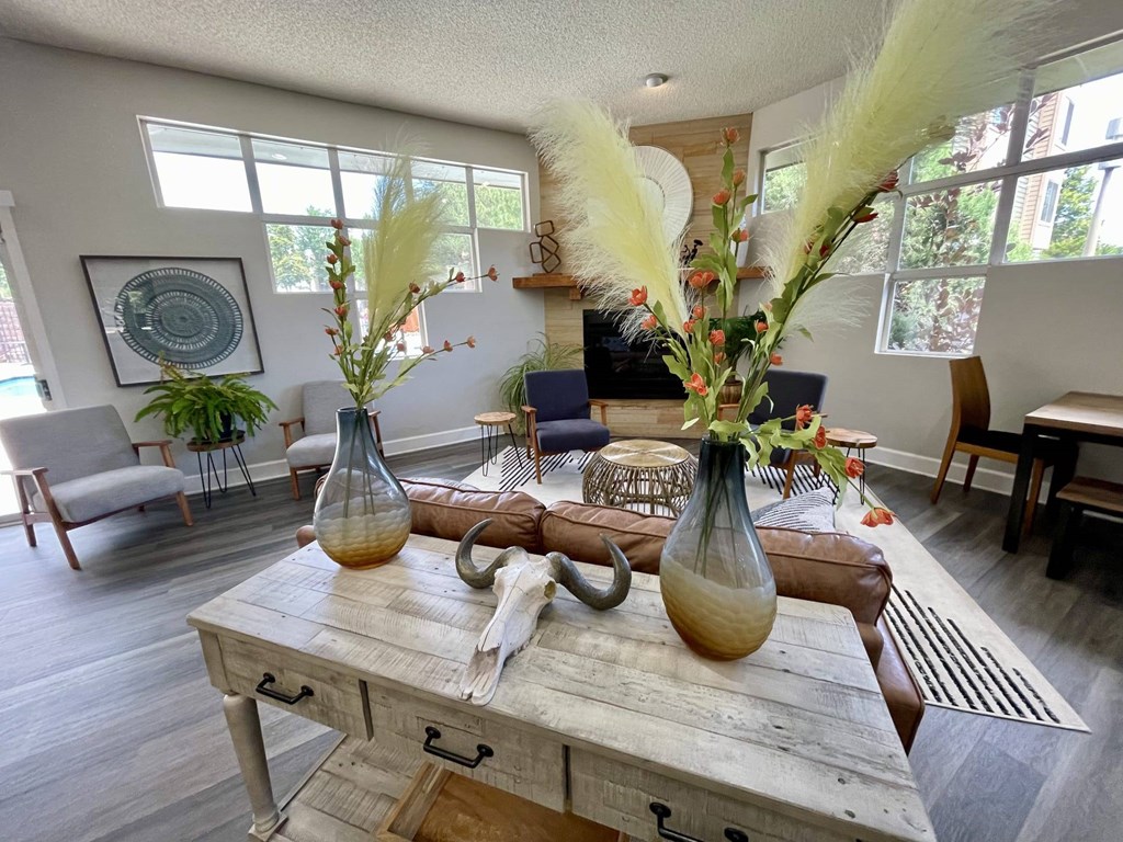 A rustic wooden table with two vases on it.
