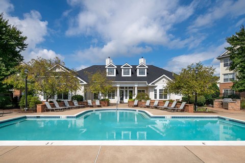 A large house with a pool in front.