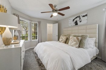 Model bedroom with large windows and ceiling fan - Photo Gallery 6