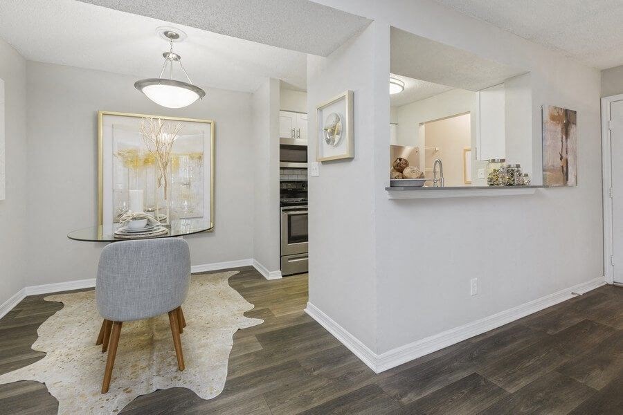 Model dining area with view of kitchen