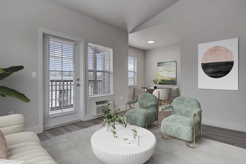 A living room with a white couch, a green chair, and a painting on the wall.