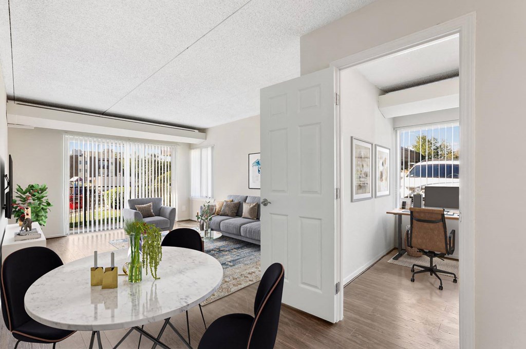 a living room and dining room with a table and chairs