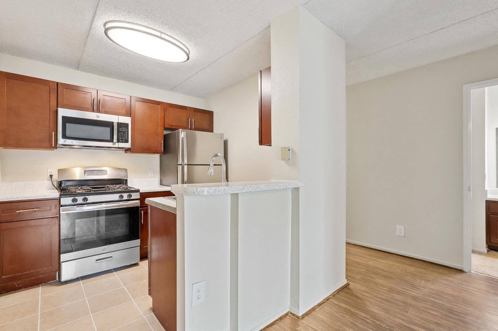 a kitchen with a island and a stove and a microwave