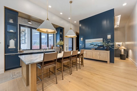 a large kitchen with a long island with chairs