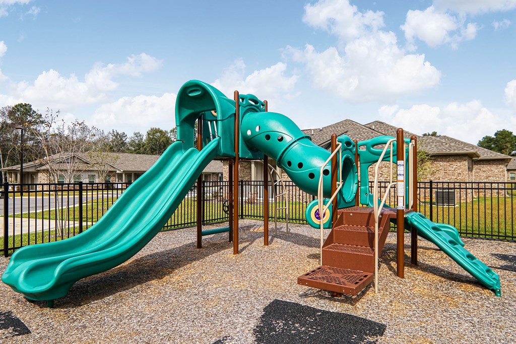 a playground with a large green slide