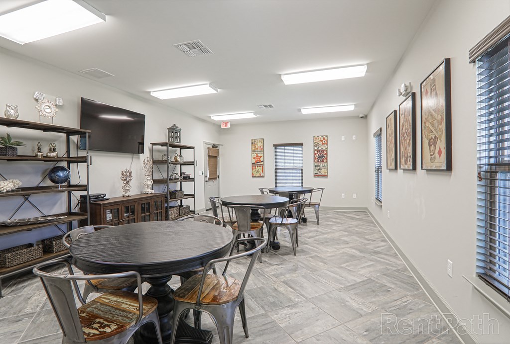 a dining room with tables and chairs and a television