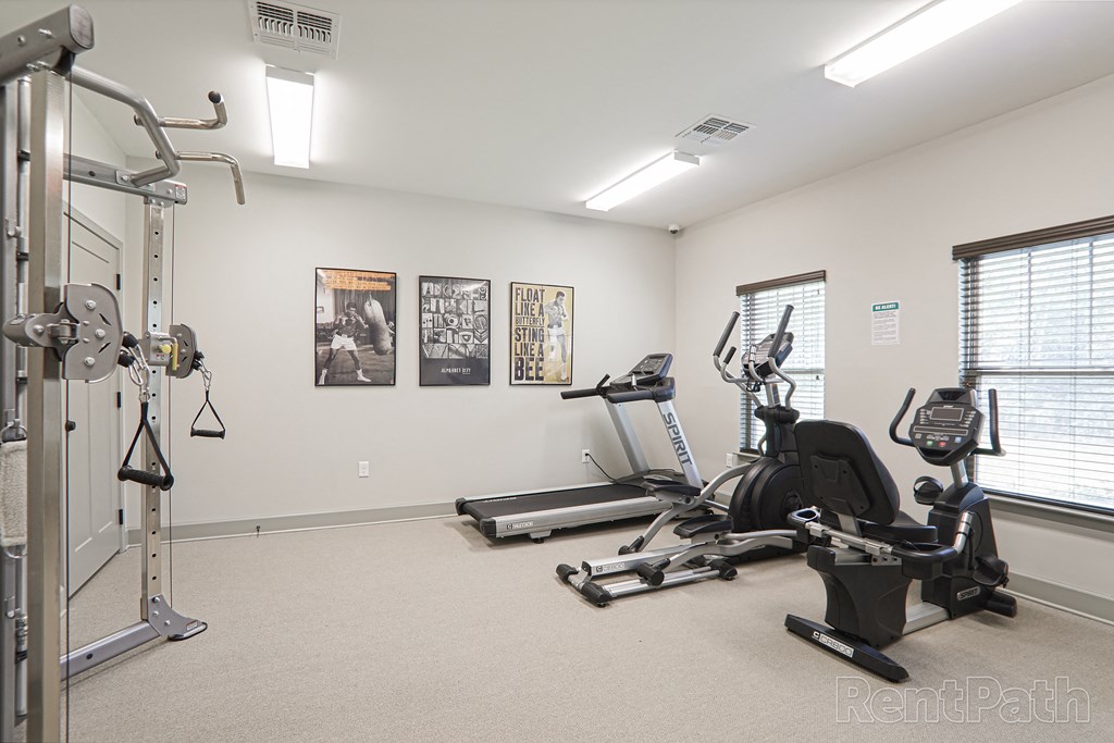 a home gym with exercise equipment and a window