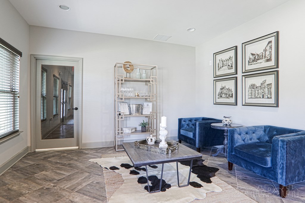 a living room with two blue couches and a coffee table