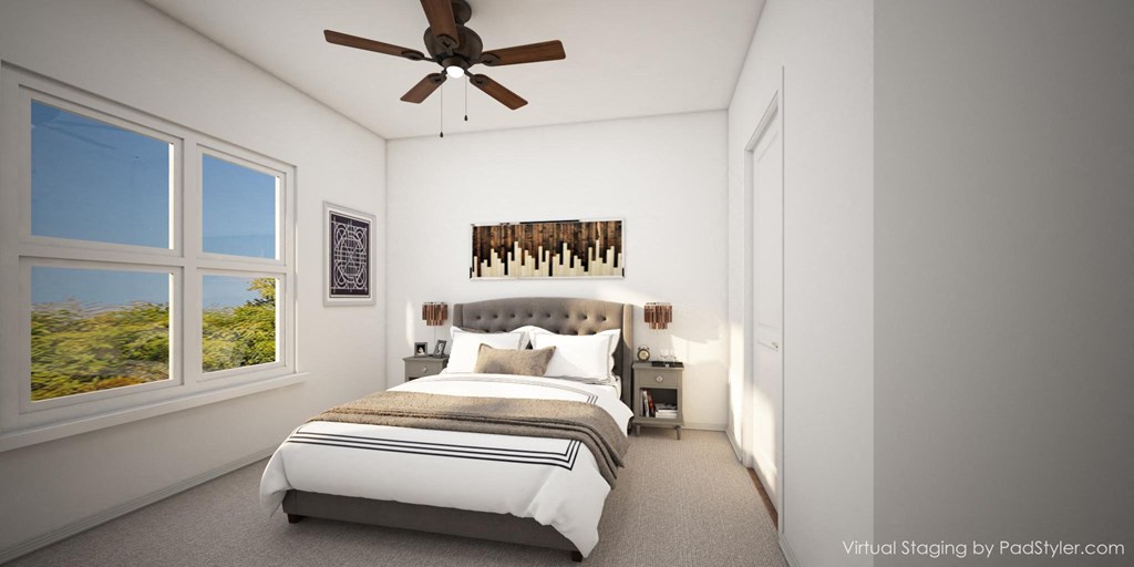a bedroom with a bed and a ceiling fan
