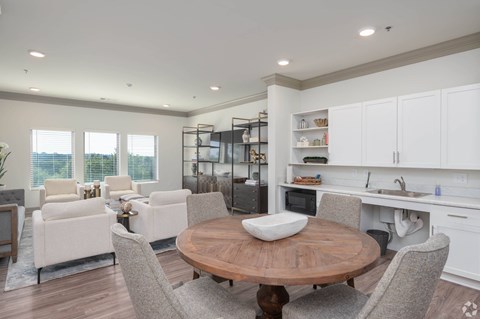 A modern kitchen with a dining table and chairs.