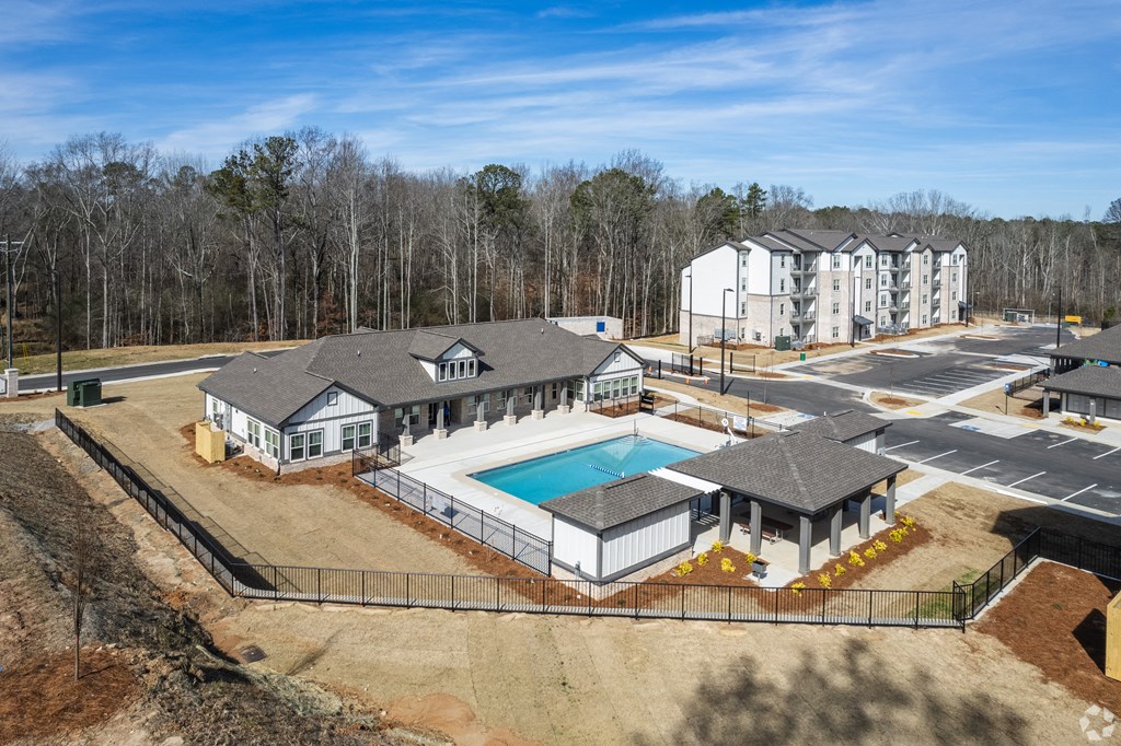 a rendering of a house with a pool and a building in the background