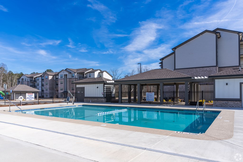 our apartments feature a swimming pool with a blue sky above it