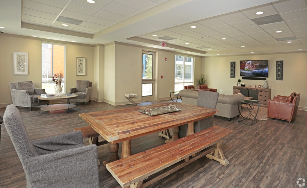 A conference room with a wooden table and chairs at Arbours at Tumblin Creek ~ Active 55+ Adult Community, Gainesville, FL 32608