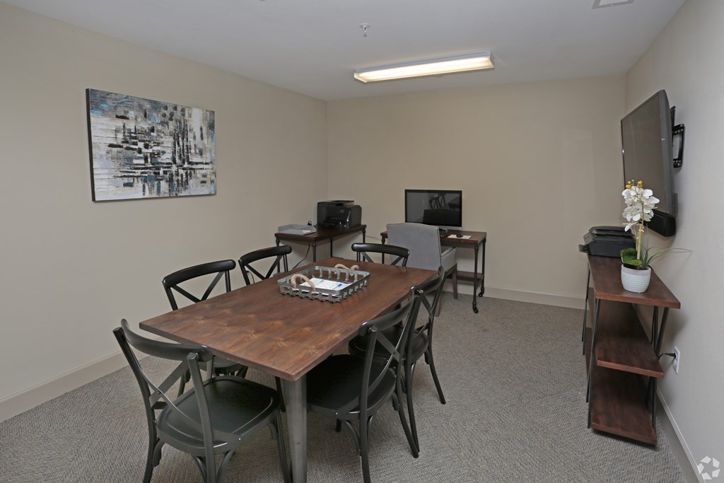 A conference room with a wooden table and chairs at Arbours at Tumblin Creek ~ Active 55+ Adult Community, Gainesville, FL