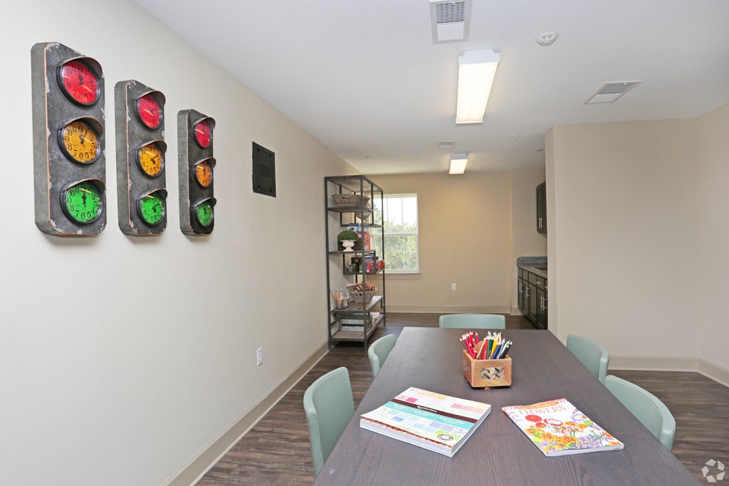 A room with a table, chairs, and a wall with traffic lights on it at Arbours at Tumblin Creek ~ Active 55+ Adult Community, Gainesville 32608