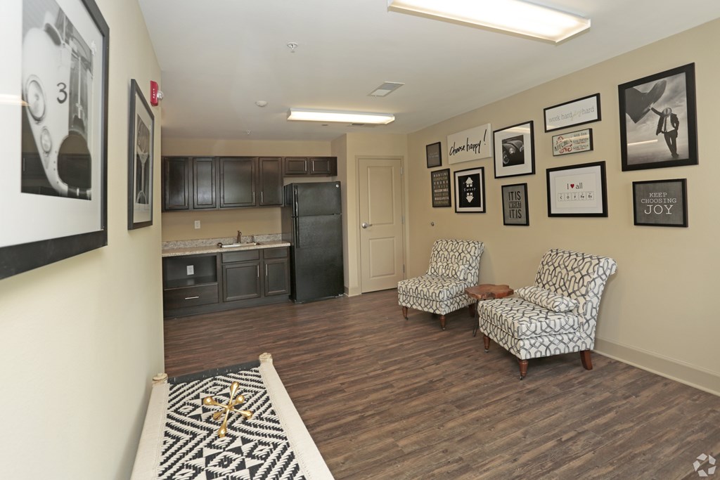 A living room with two chairs and pictures on the wall at Arbours at Tumblin Creek ~ Active 55+ Adult Community, Florida