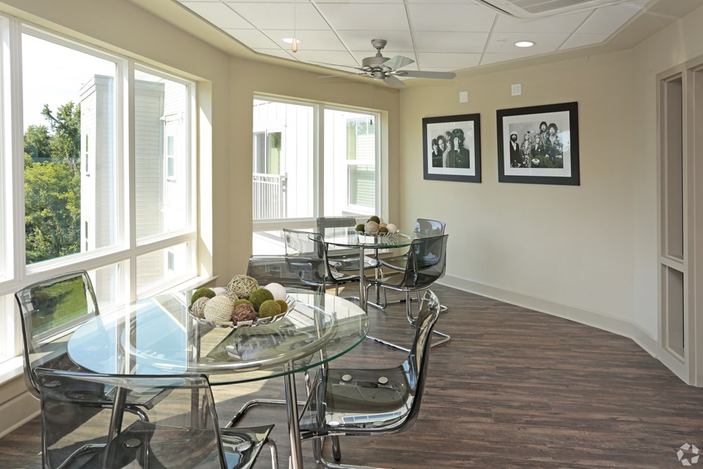 A conference room with a glass table and chairs at Arbours at Tumblin Creek ~ Active 55+ Adult Community, 32608